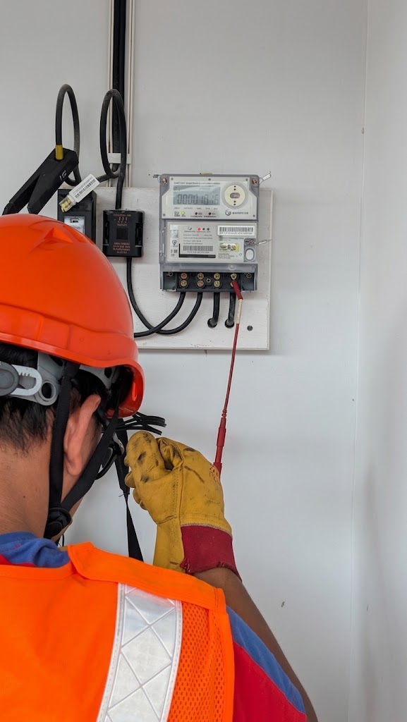 Technician performing smart meter installation and commissioning